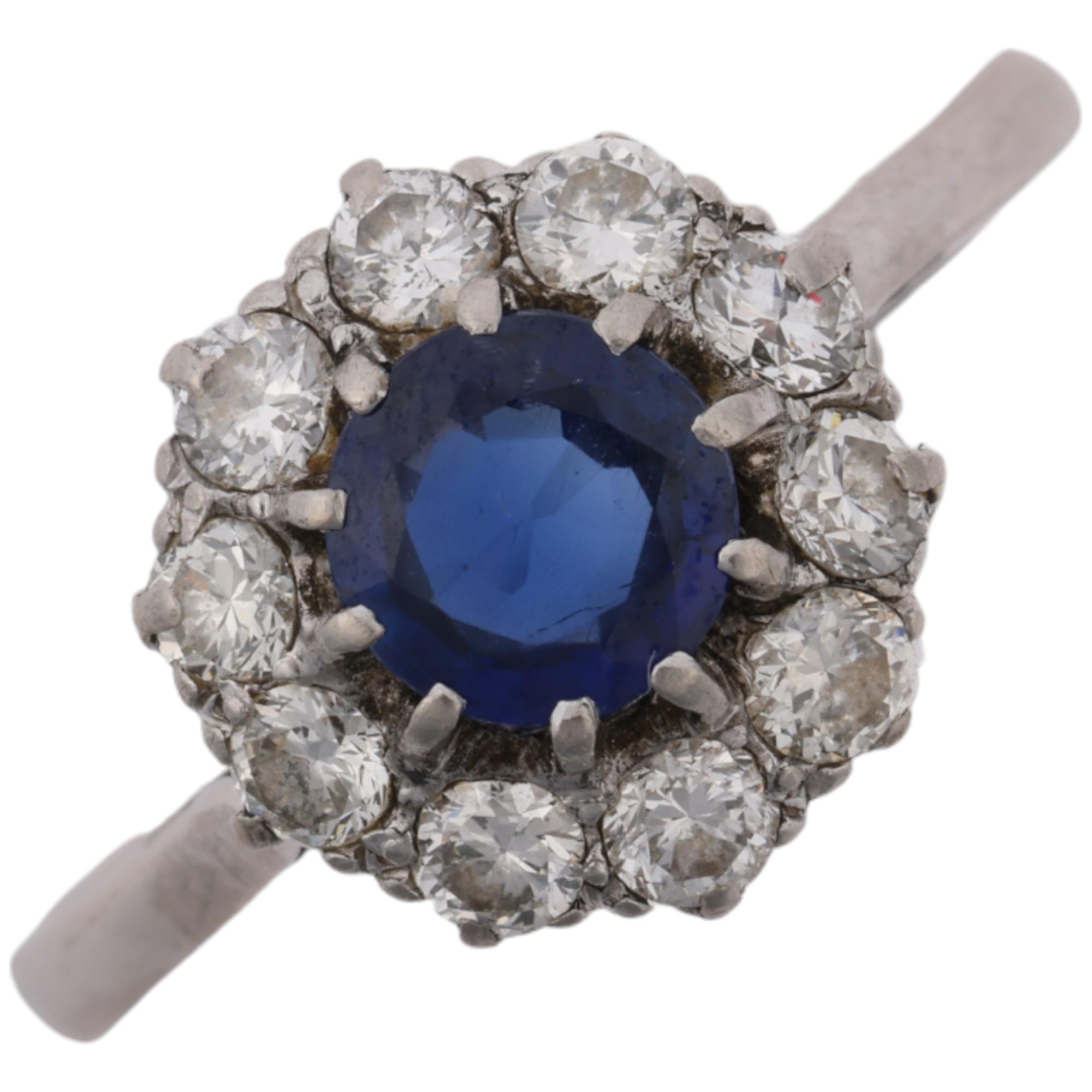 A mid-20th century platinum sapphire and diamond flowerhead cluster ring, claw set with round-cut