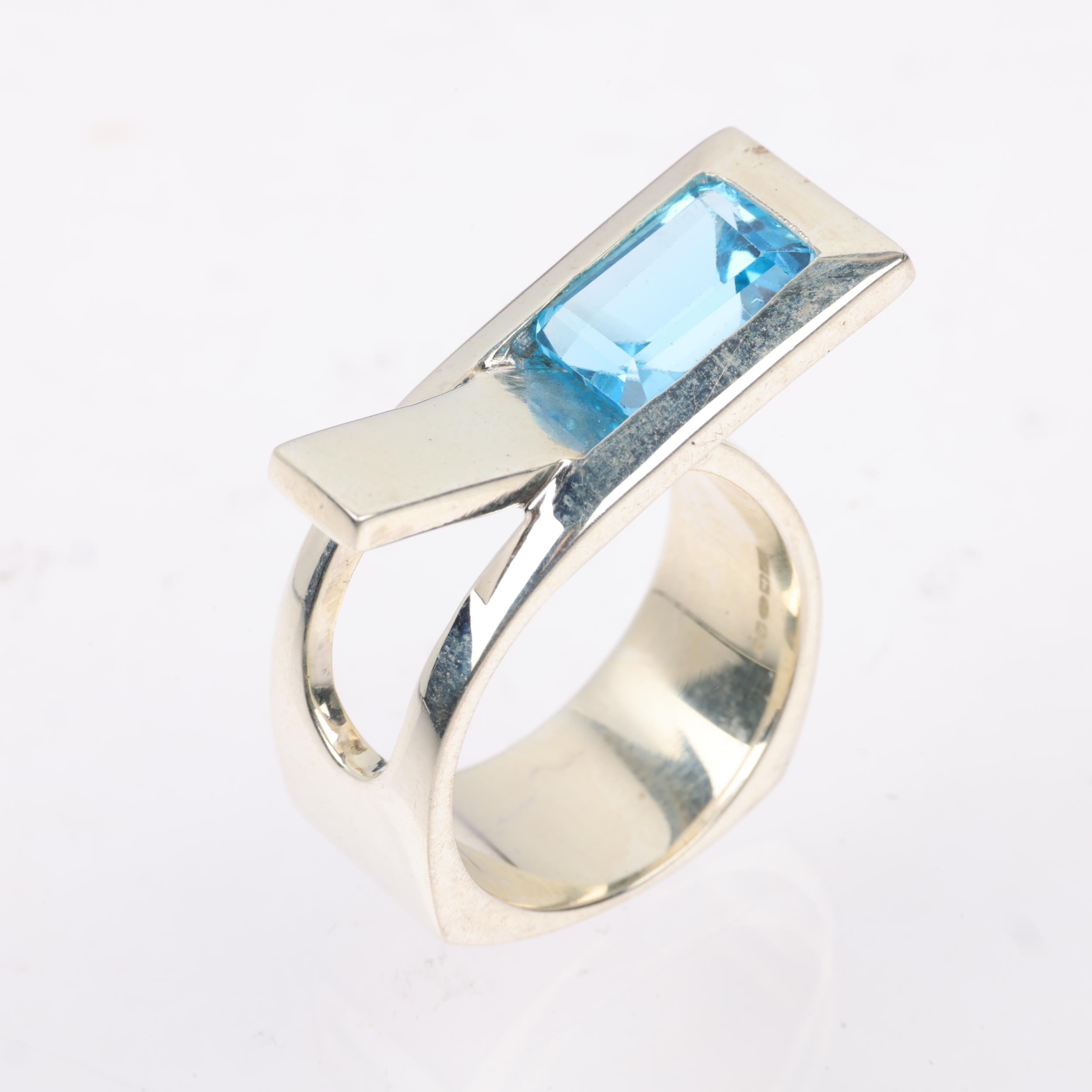 A modern sterling silver blue topaz crossover ring, London 2023, band width 11.4mm, size P, 13g - Image 2 of 3