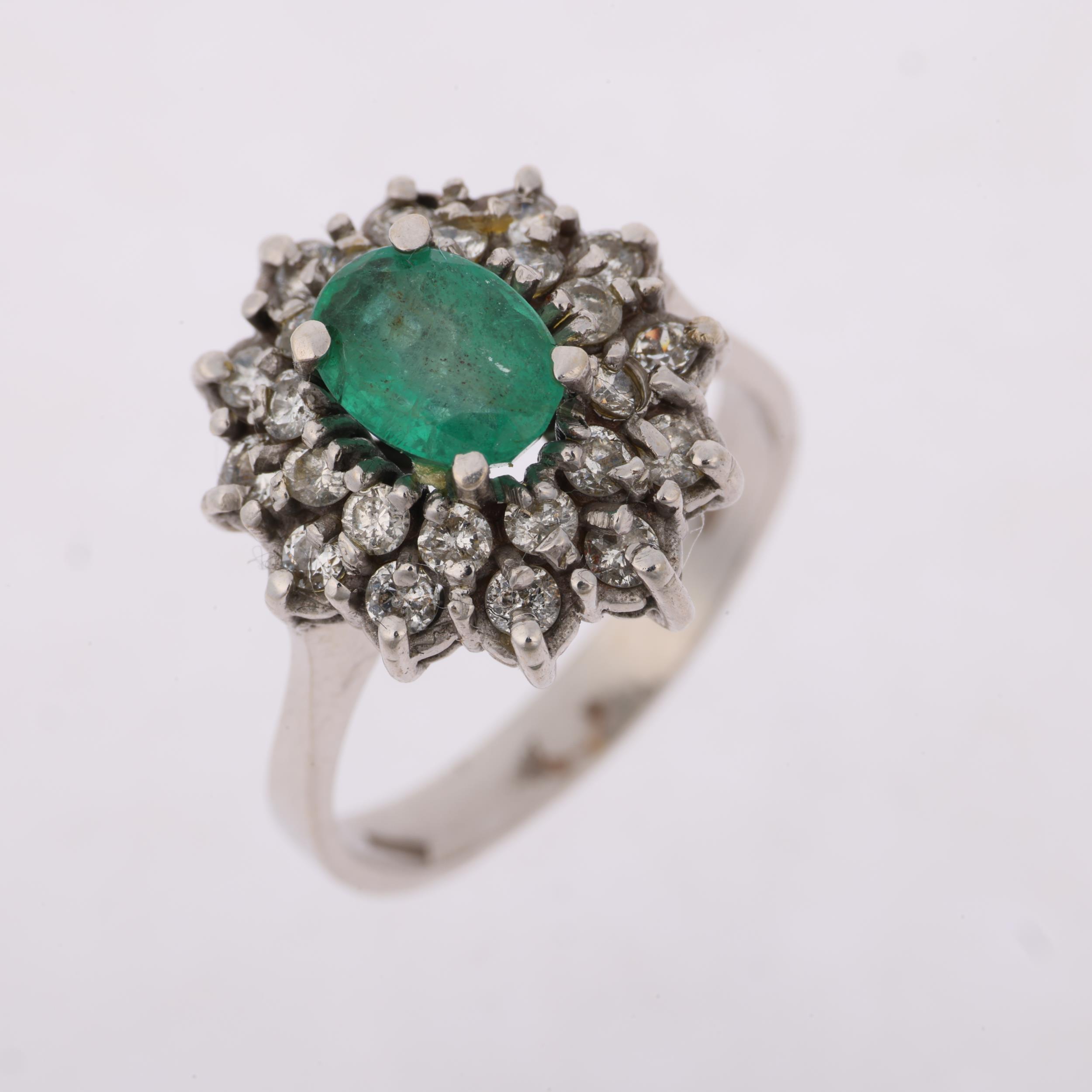 A Continental 18ct white gold emerald and diamond flowerhead cluster ring, claw set with oval - Image 2 of 4