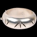 A large Mexican modernist sterling silver hinged bangle, with pierced decoration, band width 26.1mm,