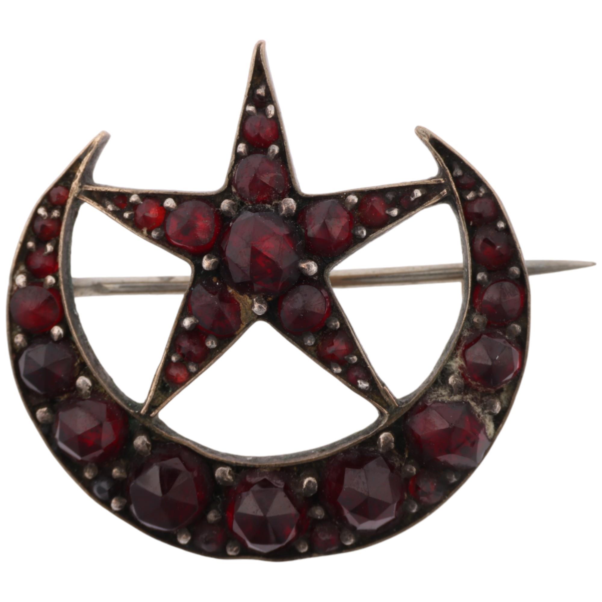 A Victorian Bohemian garnet crescent moon and star brooch, apparently unmarked, 24.2mm, 3.2g