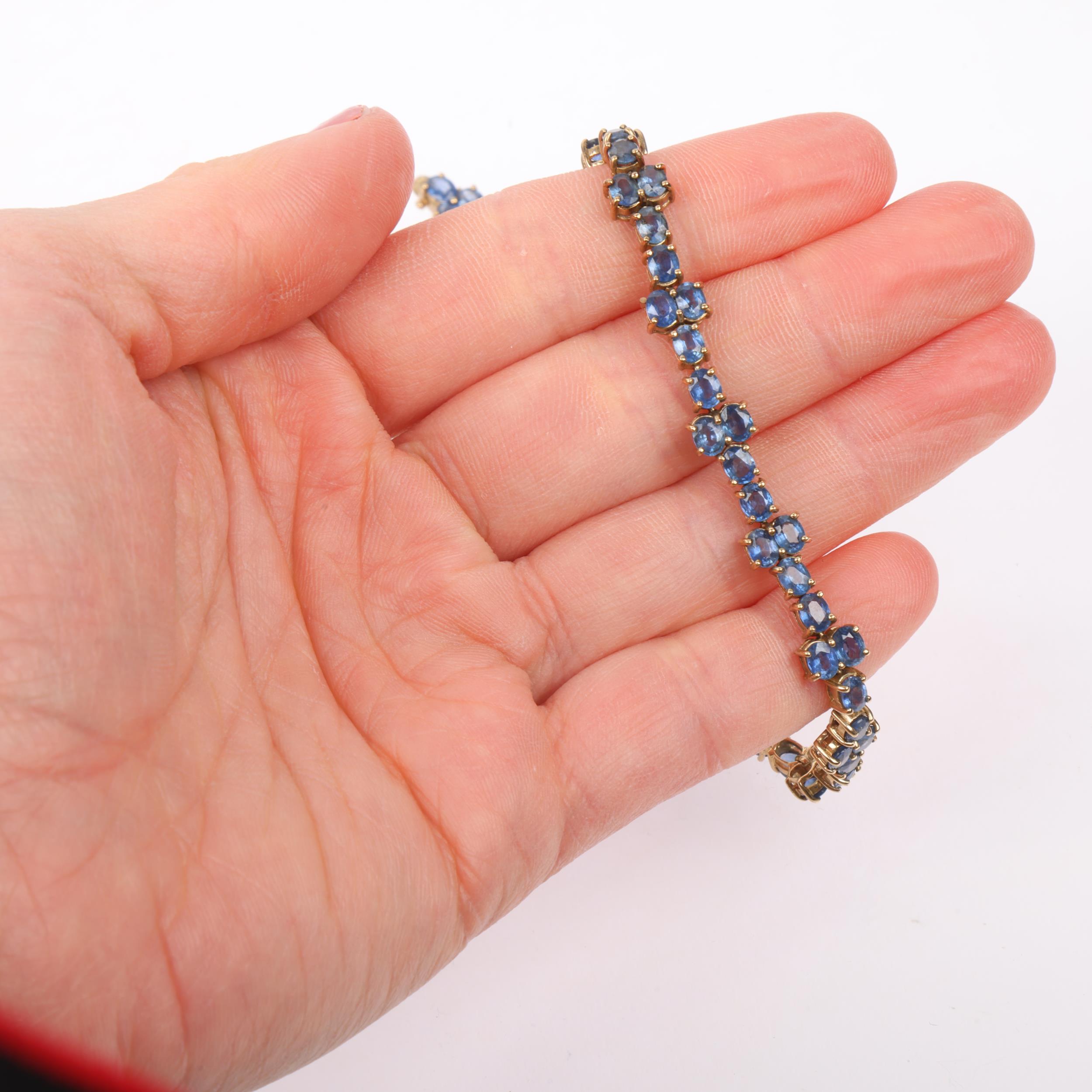 A modern 9ct gold sapphire tennis line bracelet, Birmingham 2005, set with oval mixed-cut sapphires, - Image 4 of 4