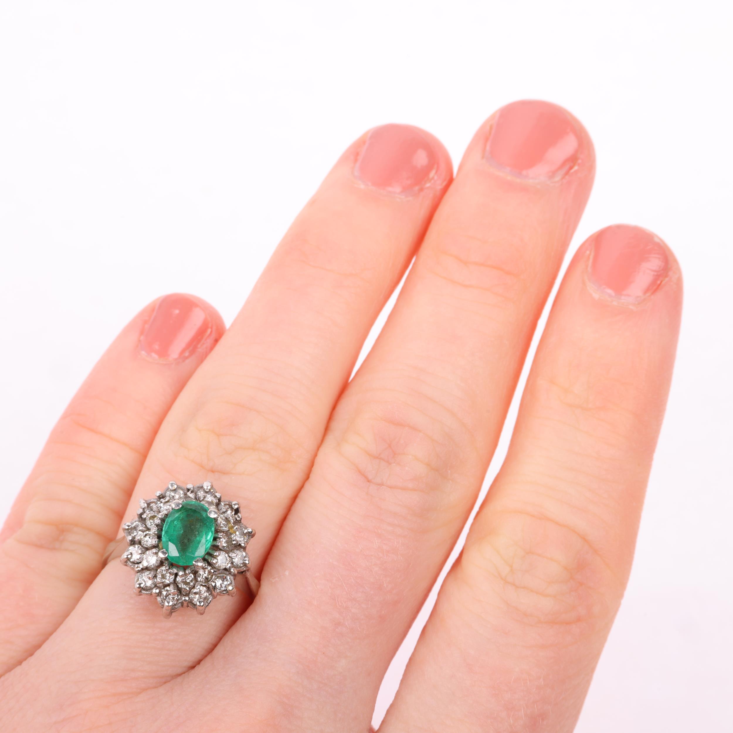 A Continental 18ct white gold emerald and diamond flowerhead cluster ring, claw set with oval - Image 4 of 4