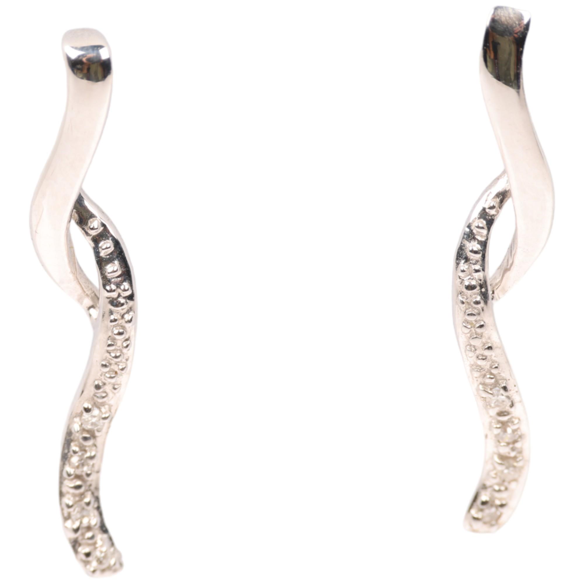A pair of 9ct white gold diamond ribbon earrings, with stud fittings, set with eight-cut diamonds,