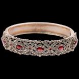 A mid-20th century silver garnet and marcasite hinged bangle, maker NCR Co, Birmingham 1958, band