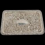 An Edwardian silver dressing table tray, Walker & Hall, Sheffield 1904, allover high relief embossed