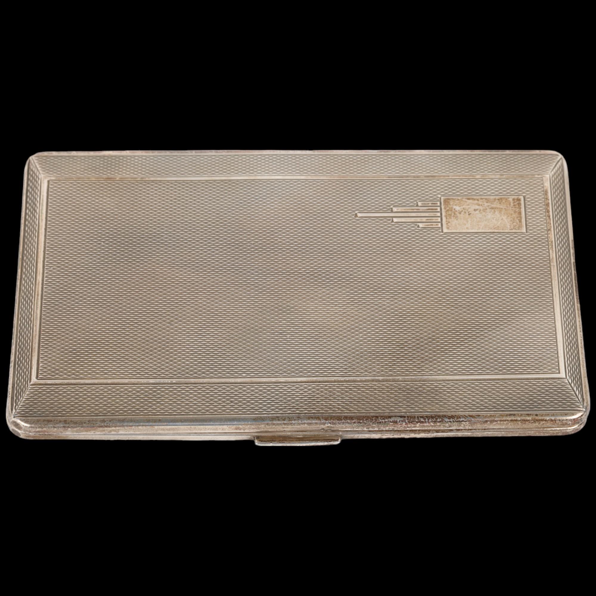 An Art Deco style George VI silver rectangular cigarette case, Harman Brothers, Birmingham 1951,