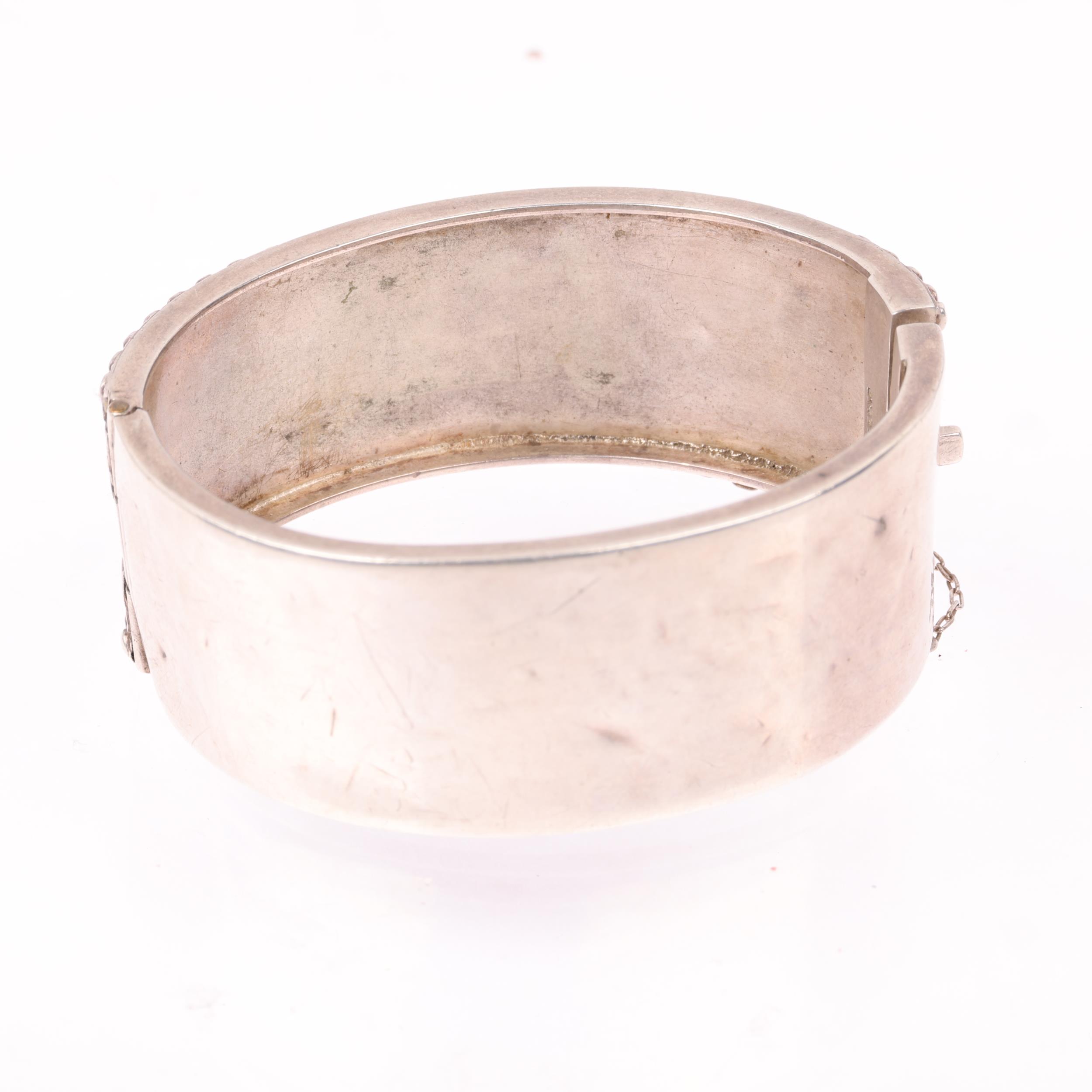 A Victorian sterling silver hinged bangle, with relief heart decoration, band width 24.8mm, internal - Image 2 of 3
