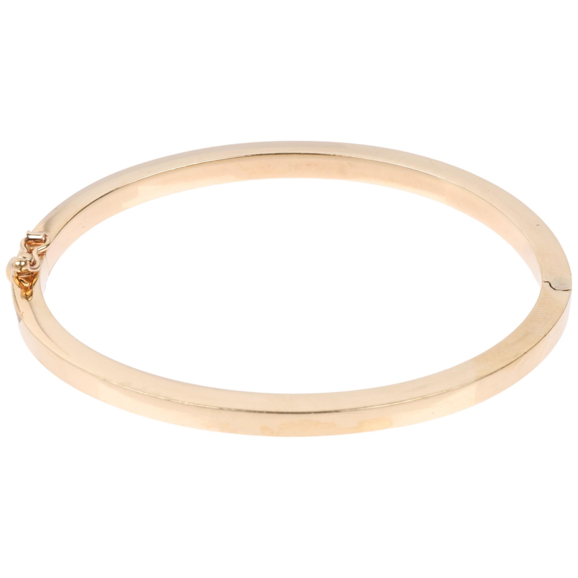 A 9ct gold plain hinged bangle, band width 4.1mm, internal circumference 18cm, 10.7g Condition