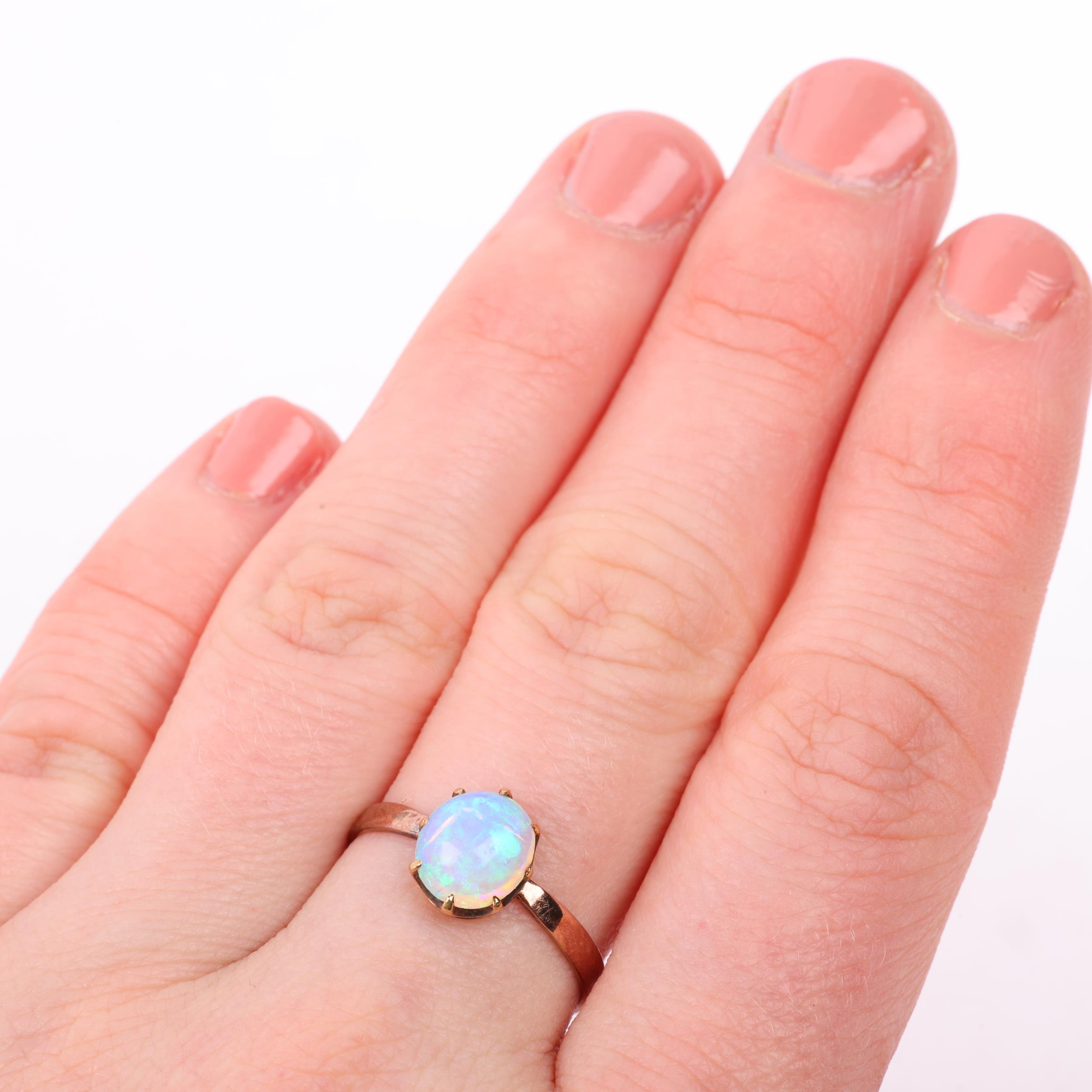 An early 20th century solitaire opal ring, claw set with 1ct oval cabochon opal, opal measures - Image 4 of 4