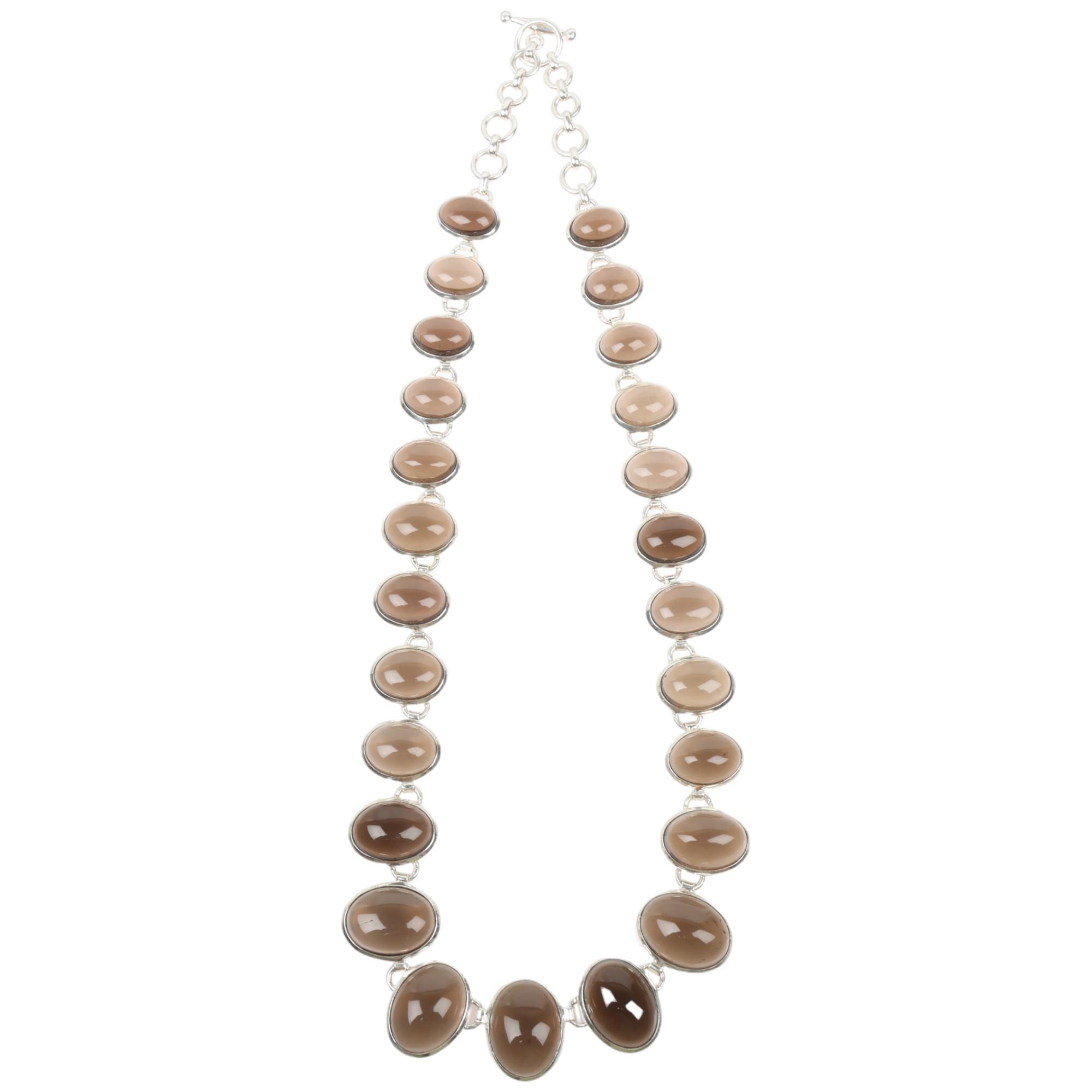 An impressive modern sterling silver graduated smoky quartz fringe necklace, set with oval