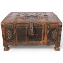 An Anglo-Indian hardwood chest, with allover relief carved decoration, complete with padlock and