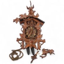 A Black Forest cuckoo clock, with carved stag head piece, H55cm approx (A/F)