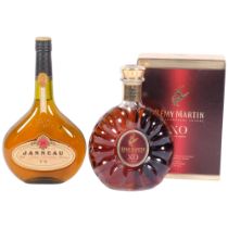 A bottle of Janneau Grand Armagnac, and a boxed bottle of Remy Martin Cognac