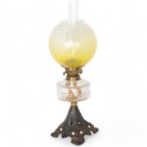 Victorian oil lamp with yellow glass shade, moulded glass font and pierced cast-iron plinth, with