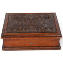 A Victorian oak sewing box, with leaf and acorn relief carved hinged lid, and a quantity of
