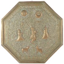A large Eastern octagonal pierced brass wall plaque with embossed design of figures, sun and moon,