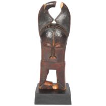 A Baule, Ivory Coast weaving pulley, carved wood masked figure on wooden plinth, height 16cm Break