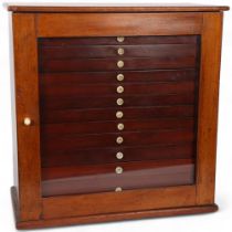 A Victorian mahogany collector's cabinet, the single glazed door showing a set of 13 fitted drawers,