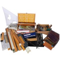 A quantity of drawing instruments, rulers, rollers, etc