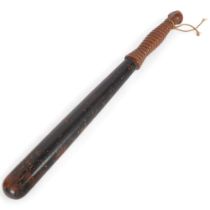 A Victorian ebonised turned hardwood truncheon, with ribbed handle, gilded crown, initialled V.R.,