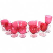 6 cranberry glass custard cups, a goblet, and 2 bowls