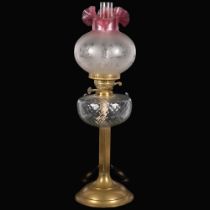 A brass duplex oil lamp, with moulded glass font and etched glass shade, with chimney, H65cm