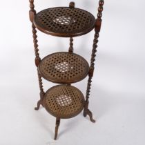 An Edwardian oak 3-tier cake stand, with cane panelled shelves on barley twist supports, H92cm