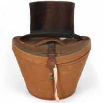 A French canvas and leather-mounted hat box, together with a silk top hat, maker's from Rouen,