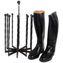 A wrought-iron boot tree stand, and a pair of French black riding boots, size 43, stand height 57cm