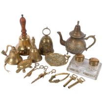 4 brass bells, embossed brass teapot, H23cm, a glass desk stand, nutcracker, candle snuffers, etc