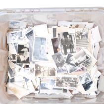 A box with a large collection of black and white family photographs, etc