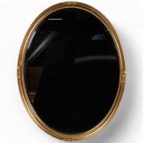 An oval gilt wall mirror, with bevel-edged glass, 65cm x 50cm