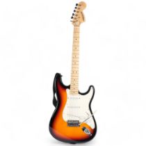 A Starcaster Strat electric guitar by Fender, in associated softshell case