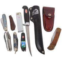 A group of various penknives, including a Victorinox, Wilkinson Sword, and a Rapala fisherman's