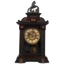 A brass dial 2-train mantel clock, in carved stained wood case with horse pediment, height overall