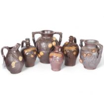 3 terracotta Calvados jugs with applied decoration, 2 similar vases and a jug with applied fruit and