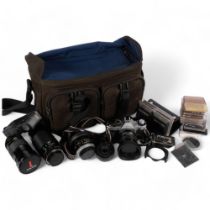 A selection of Vintage cameras and associated equipment, including a Canon AE-1 Programme camera,