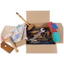 A box of hand tools, including hammers, chisels and spanners