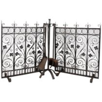 A 4-piece wrought-iron companion set on stand, H64cm, and pair of wrought-iron and mesh fire guards