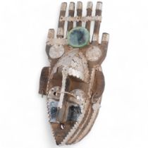 A Mali hardwood mask decorated with press metal and mirrored glass adornments, H40cm