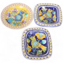 A group of 3 faience style pottery wall-hanging plates, in vibrant colours, with exotic bird and