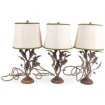 A set of 3 copper table lamps, with oak leaf and acorn decoration, and matching shades, height