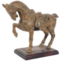 A patinated metal Tang style horse on stand, H24cm