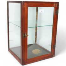 An early 20th century stained pine-framed table-top display cabinet, with all-round glazed panels