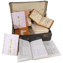 A case containing a large number of Japanese notebooks, some with entries