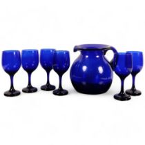 A handblown Bristol blue glass jug, H21cm, and 6 matching wine goblets