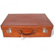 A Vintage brown leather suitcase, retailed by Harrods Ltd, impressed C.E.T to the lid, W61cm