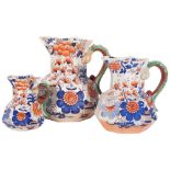 A graduated set of 3 Victorian Masons Imari style jugs, with serpent handles, tallest 22cm (with