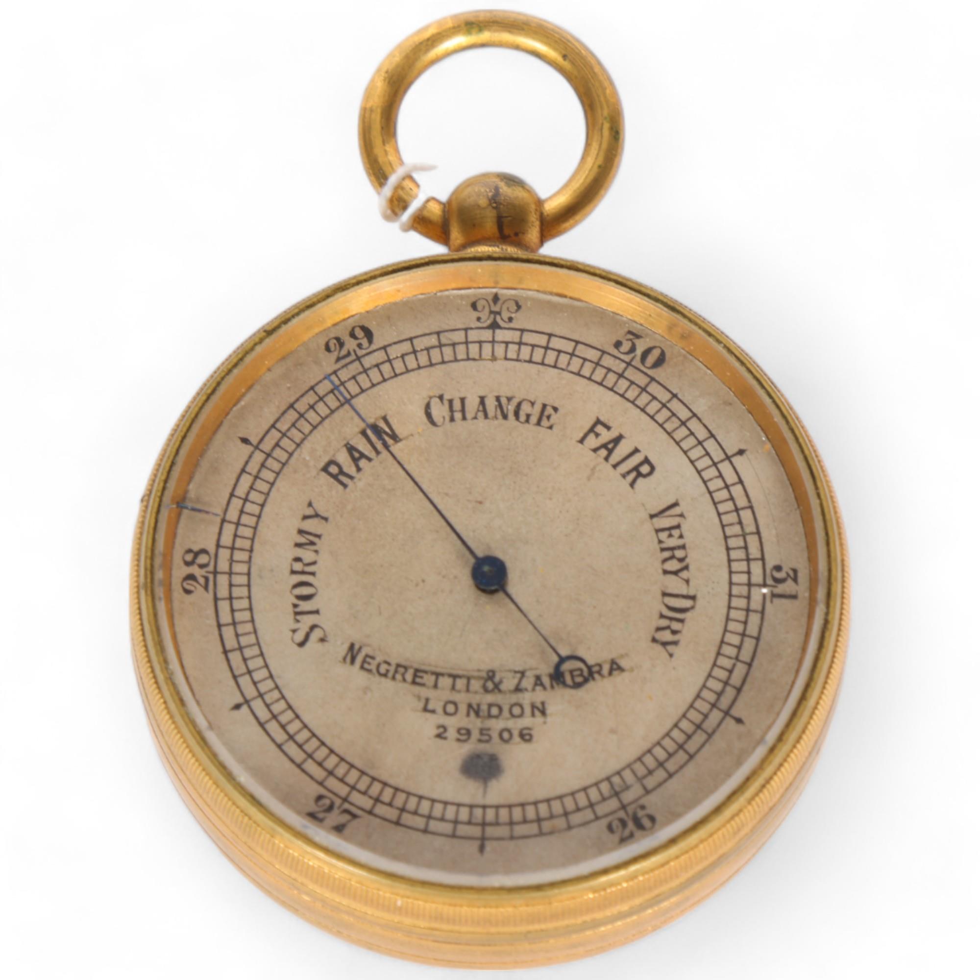NEGRETTI & ZAMBRA - a gilt-metal pocket barometer, serial no. 29506, diameter 5cm